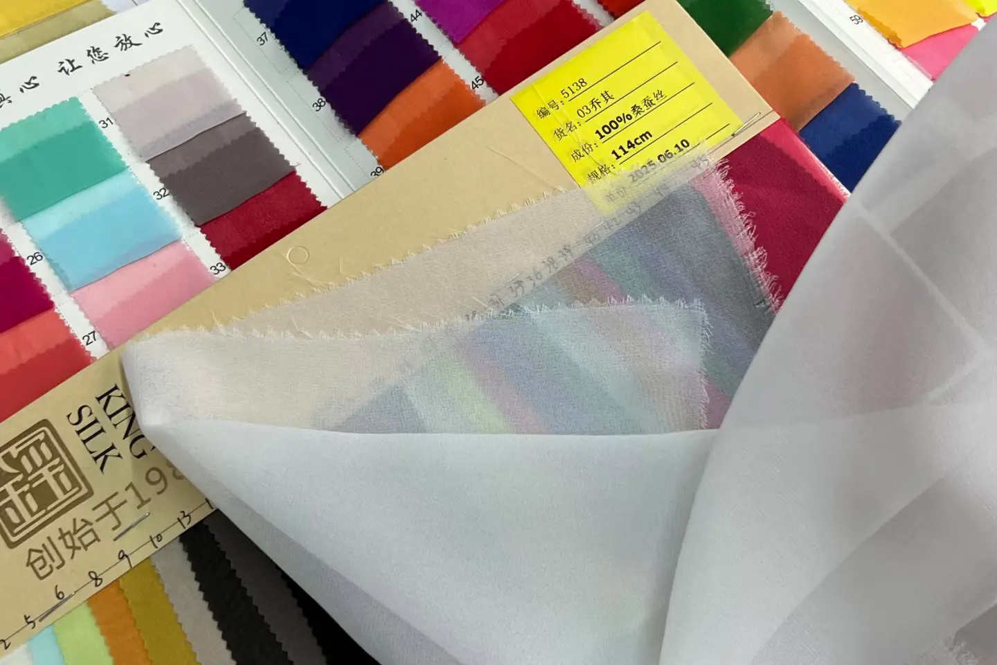 Silk fabric sample checked against light for transparency