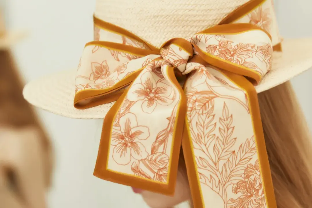 Gold floral silk bow.