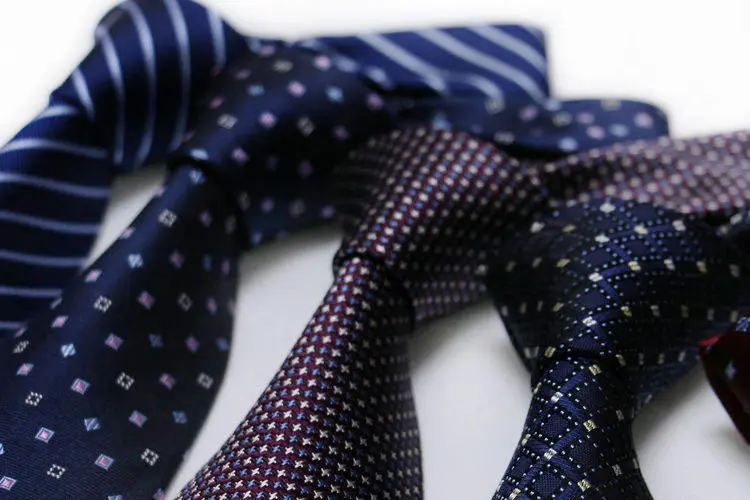 Navy polka silk necktie.