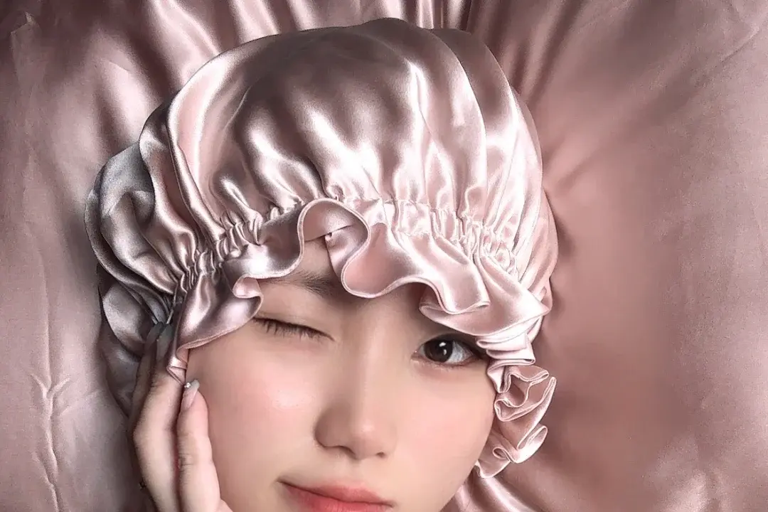 Pink ruffle silk bonnet.