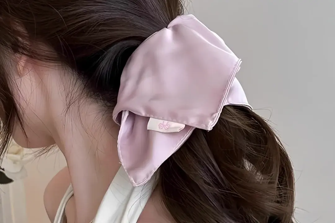 Pink silk hair bow.