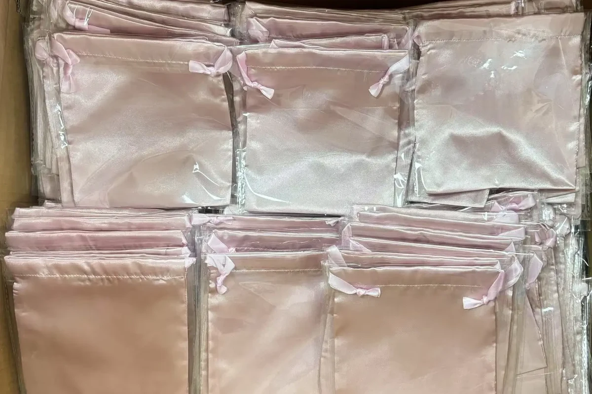 Bulk custom silk pouches organized for inspection and packing
