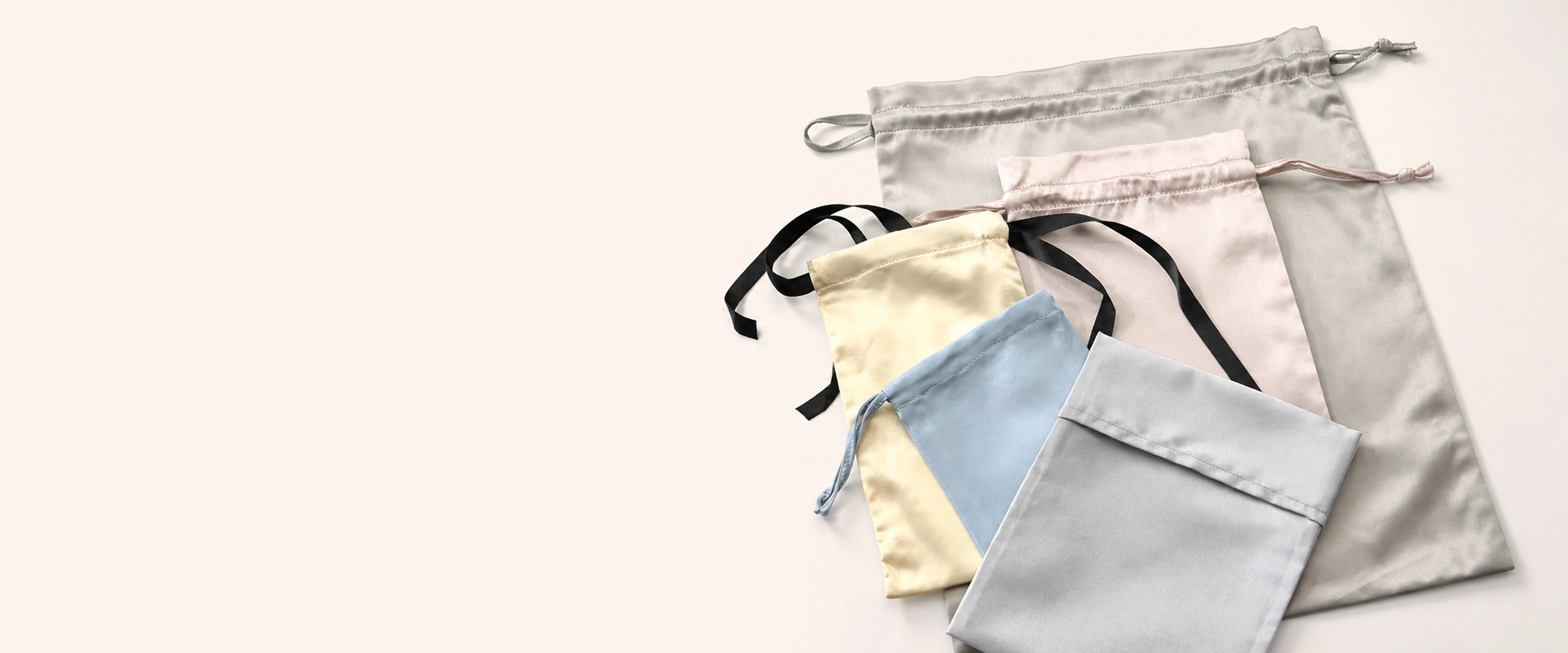 Custom silk gift pouches in assorted sizes, shapes, and drawstring styles
