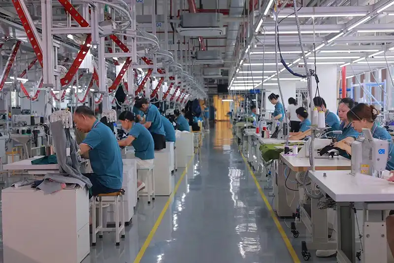 Workers sewing custom silk scarves in the factory workshop