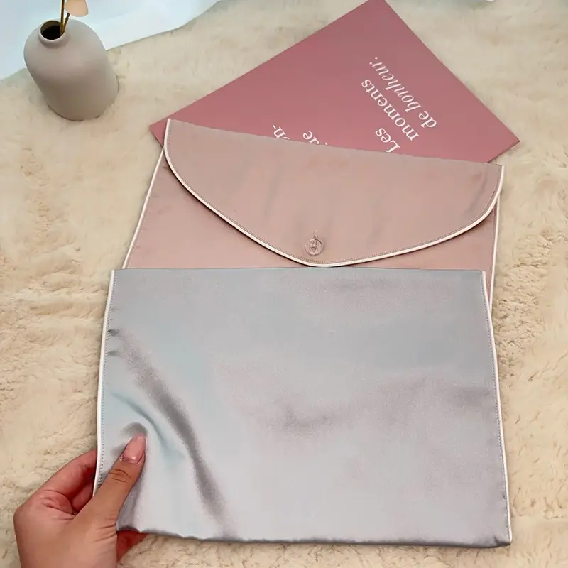 Open silver silk envelope bag showing inner pocket construction
