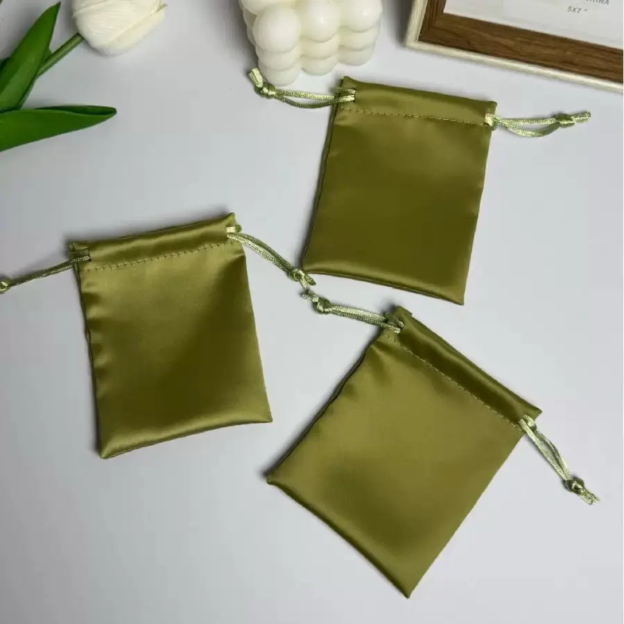 Three olive green satin jewelry pouches in small sizes