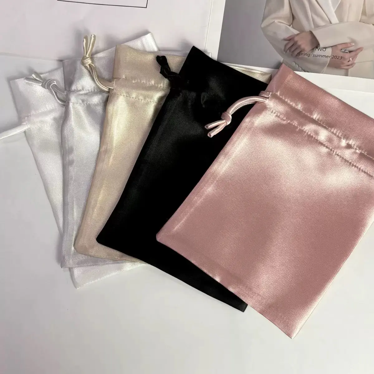 Satin drawstring favor bags in white gold black and blush