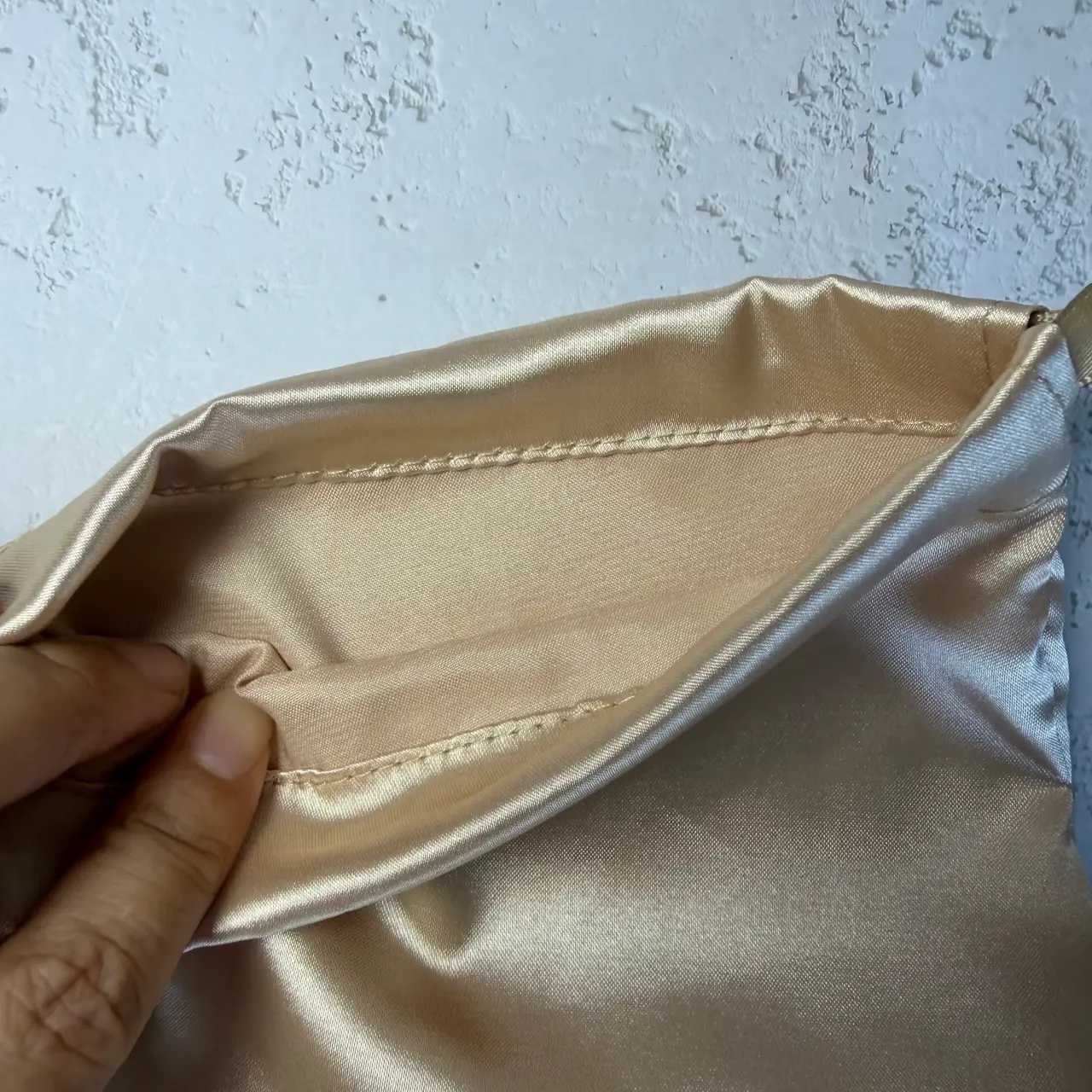 Champagne satin favor pouch showing interior stitching