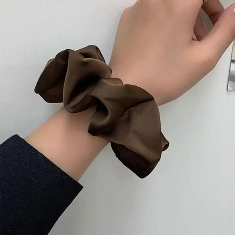 Custom logo silk scrunchies produced for promotional campaigns and events