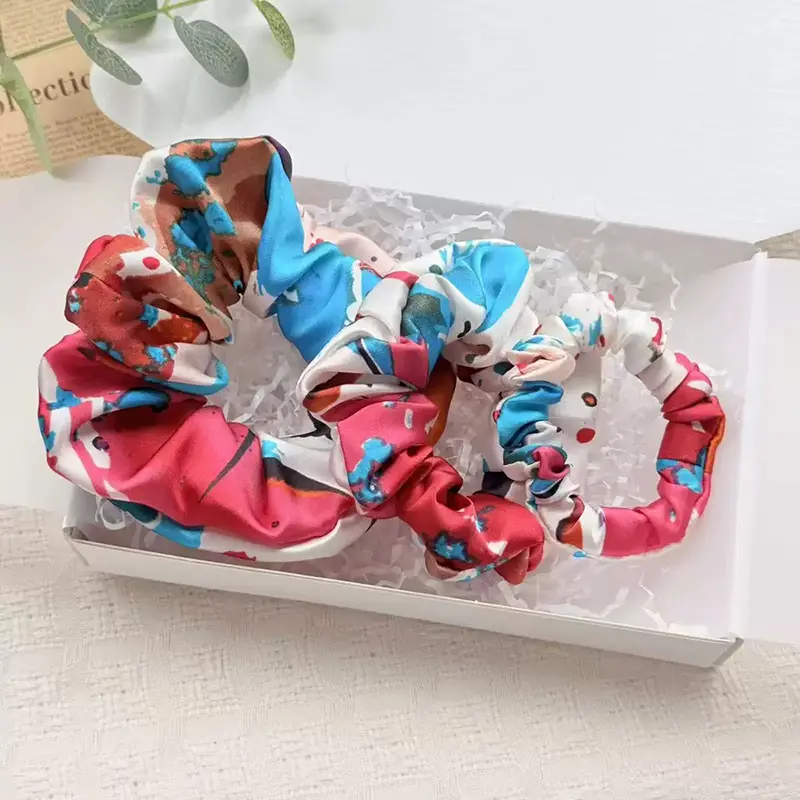 Custom printed silk scrunchie with full-color artwork and brand patterns